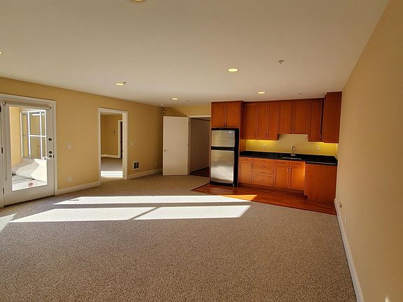 ONE OF TWO LIVING ROOMS: DOWNSTAIRS LIVING ROOM W/ WET BAR AND ACCESS TO THE BEDROOM & SUN DECK