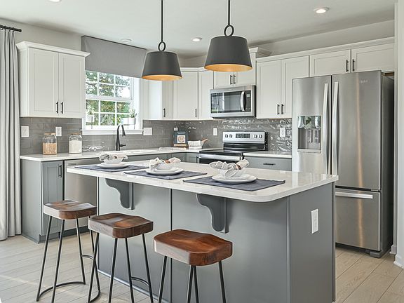 Enjoy the spacious Carnegie II kitchen with stainless steel appliances and a large center island.