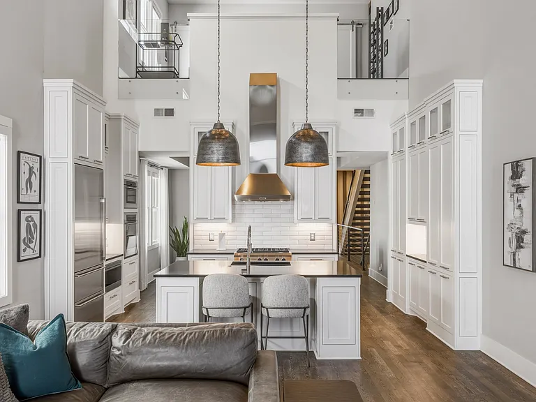 The chef's kitchen boasts a massive island, pantry wall, Wolf steam & convection ovens, a 6-burner 36" gas range and Sub-Zero refrigerator. Everything you need to cook at home, plus island seating and a dining table/room.
