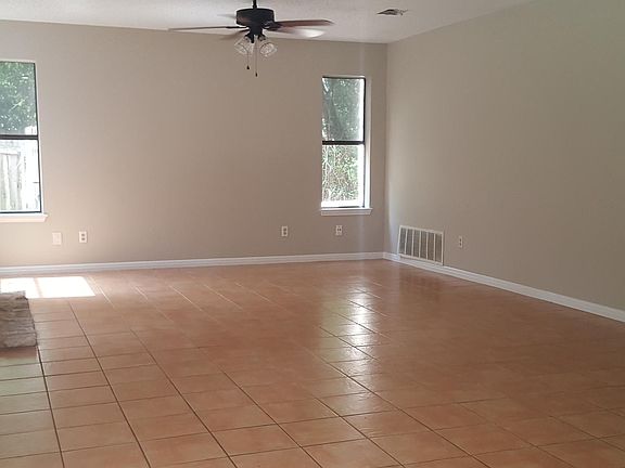 Back living room with fireplace and multiple windows facing back yard and 2 facing side yard area