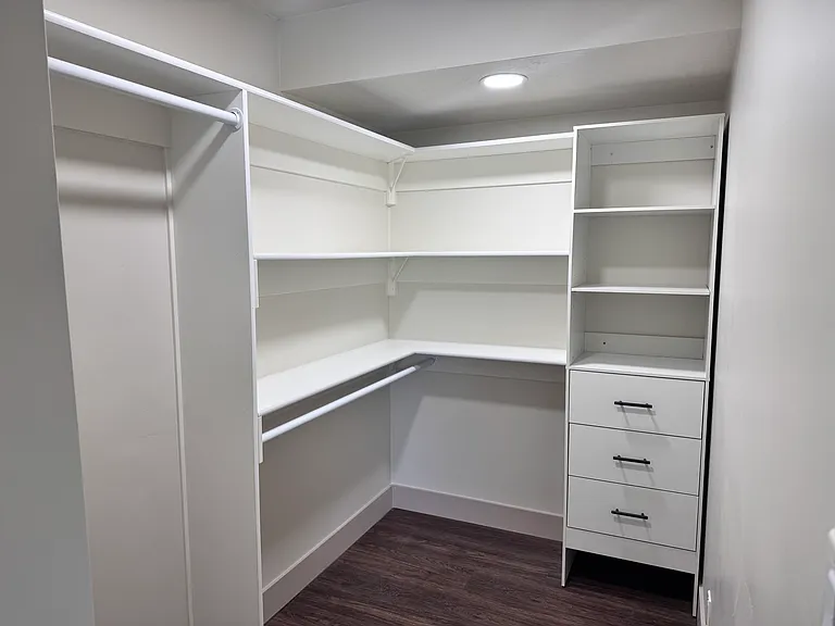 Spacious walk-in closet in the primary bedroom with built-in shelving and ample storage.