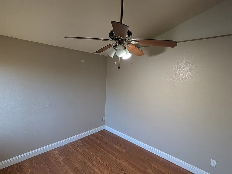 Bedroom 1 (upstairs) with window overlooking backyard