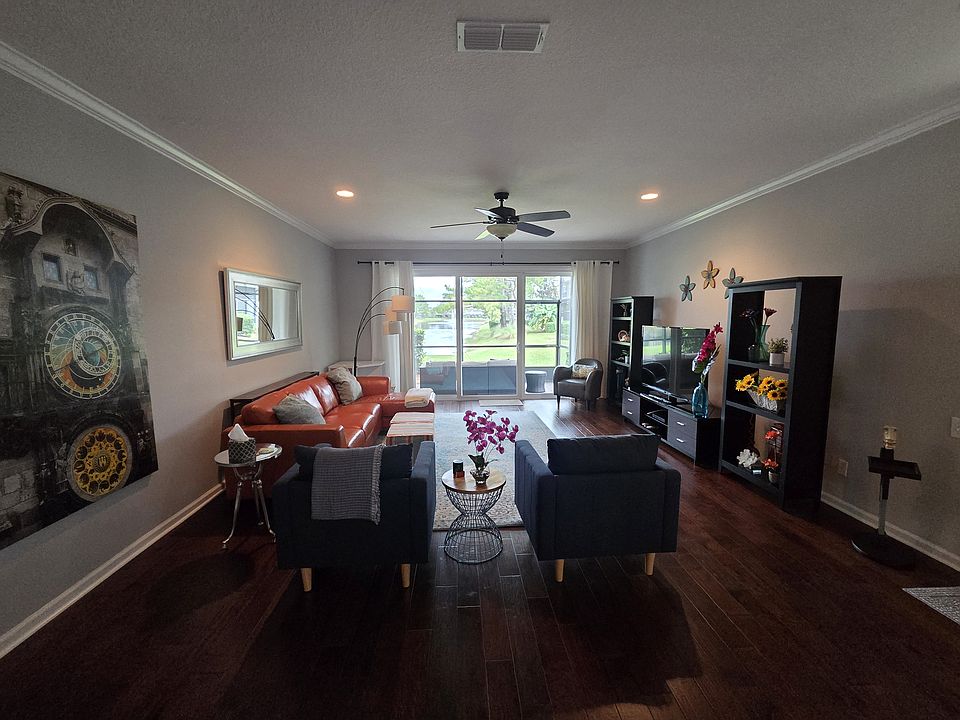 Spacious furnished living room with modern decor and hardwood floors