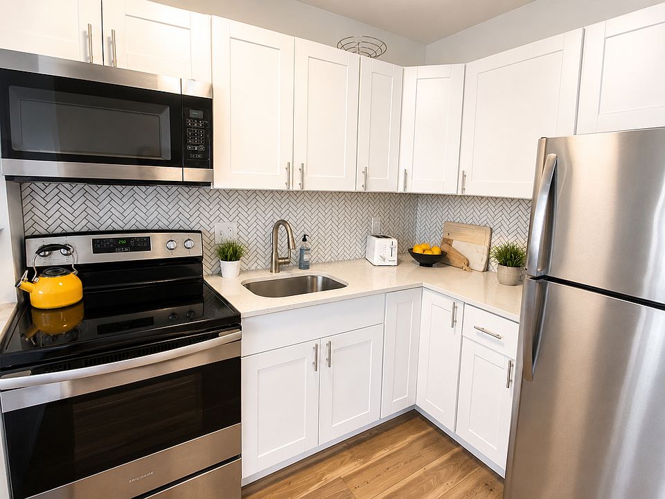 Quartz counter tops, shaker white cabinets and stainless steel appliances
