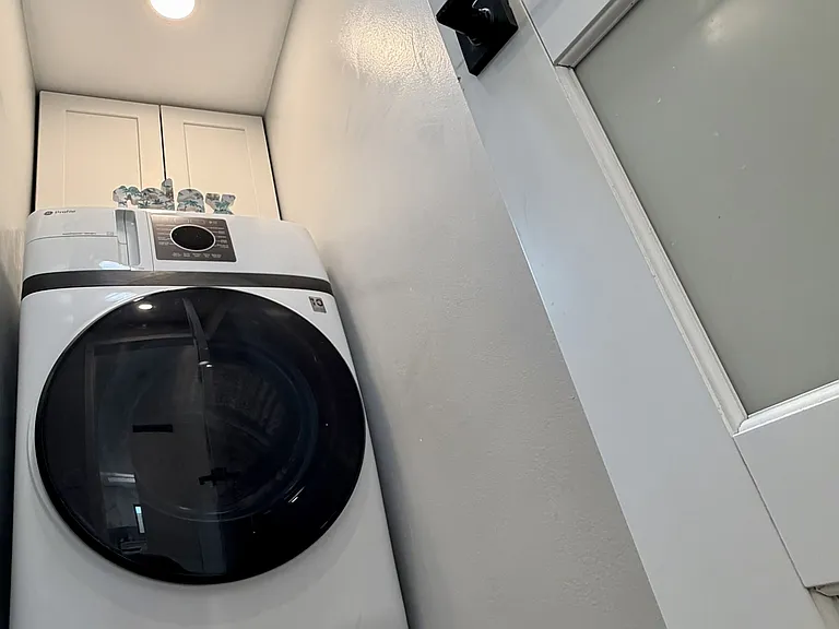 All-in-one washer/dryer combination, cabinet, and skylight