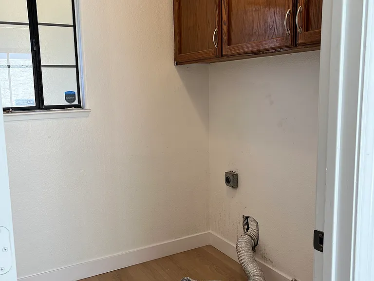 Indoor laundry room with plenty of storage.