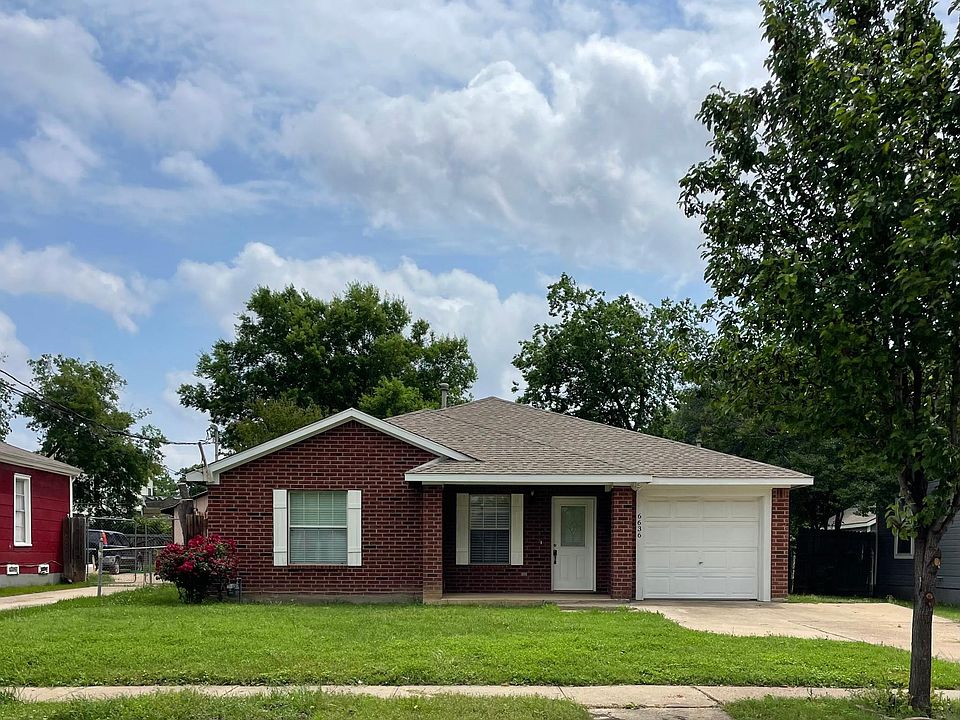 View of front of property featuring the front lawn, garage, and additional parking in driveway