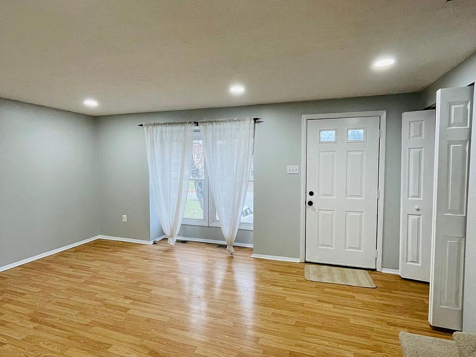 Living room with 2 large windows for natural lighting and modern recessed lighting.