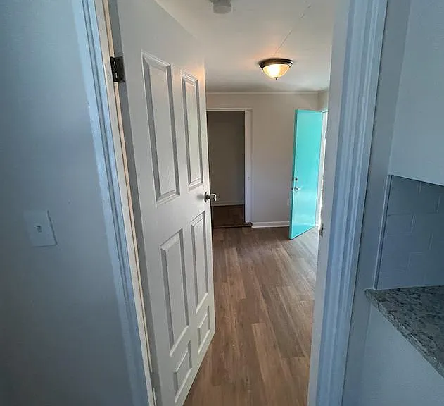 entrance from kitchen into bonus 3rd bedroom or office leading out to yard