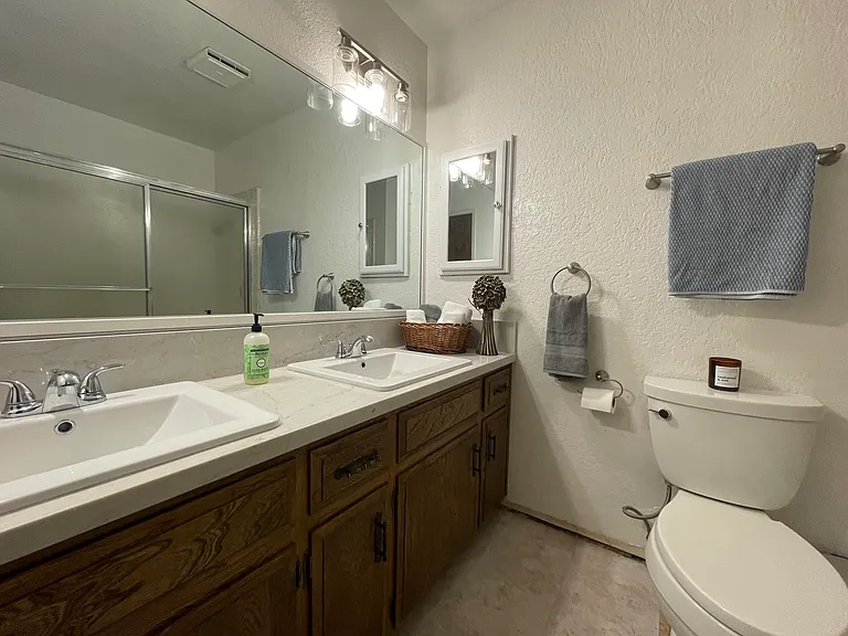This photo was taken during baseboard renovation and floor renovation... floor is now marble-pattern ceramic tile that matches the marble countertop/vanity