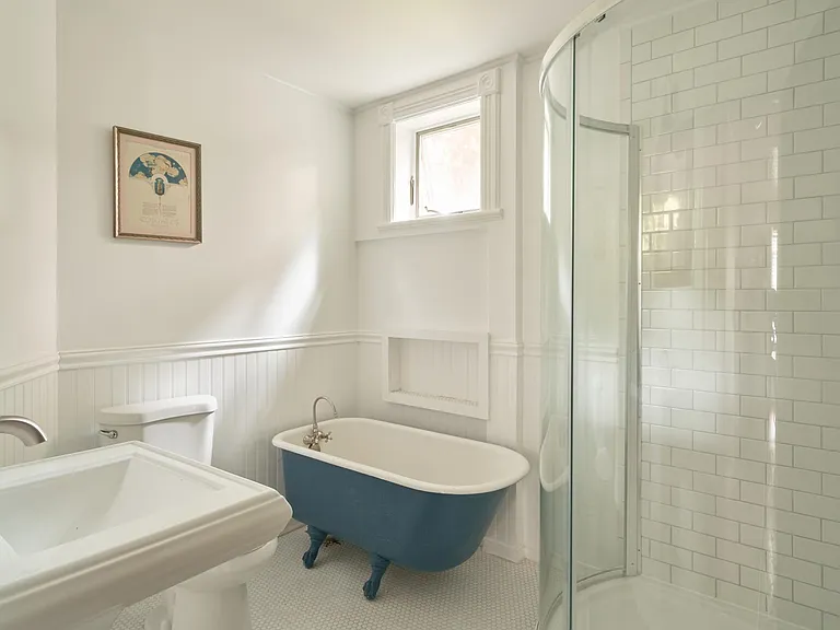 Bathroom 1 with shower and claw-foot tub. All subway tile.