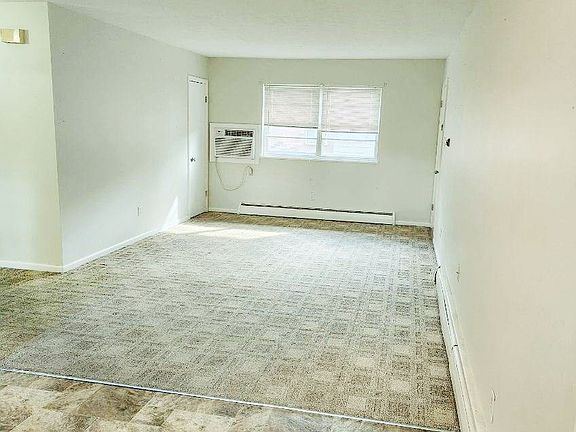 Living area with coat closet and view of court yard