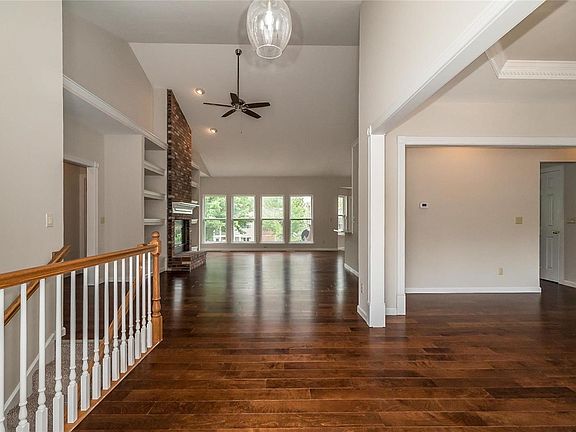 The view from the Entry offers a glimpse of the dramatic, yet comfortable plan.  New engineered hardwood graces the public spaces of the home.  The area to the right is the Dining Room.  The stairway to the left of the photo leads to the finished lower level.  New Lighting really elevates the spaces.