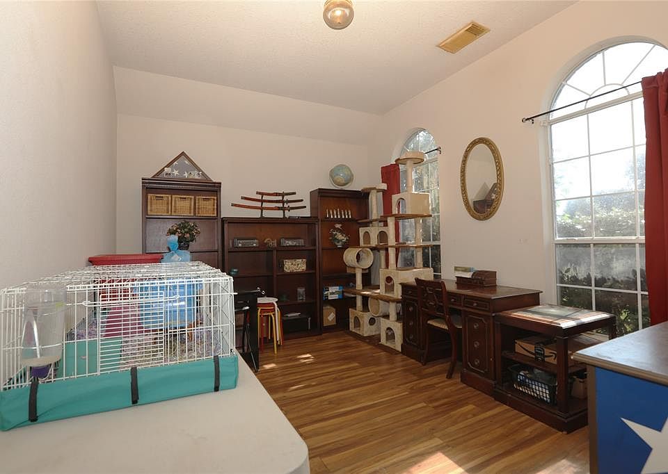 The study is currently being used to store classroom items for the summer. Located off the main entry, the arched windows overlook the front yard.