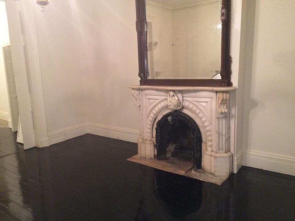 Front parlor with marble mantle and mirror.