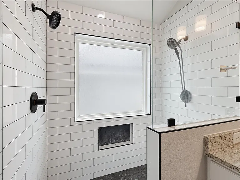Upgraded walk-in shower with dual showerheads