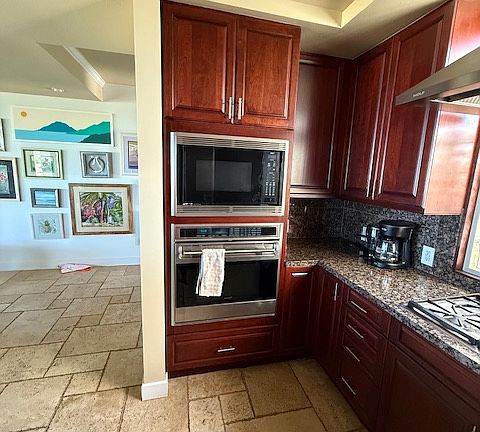 Wolf stove, microwave, and five burner gas range. Whirlpool dishwasher (not visible from this angle)