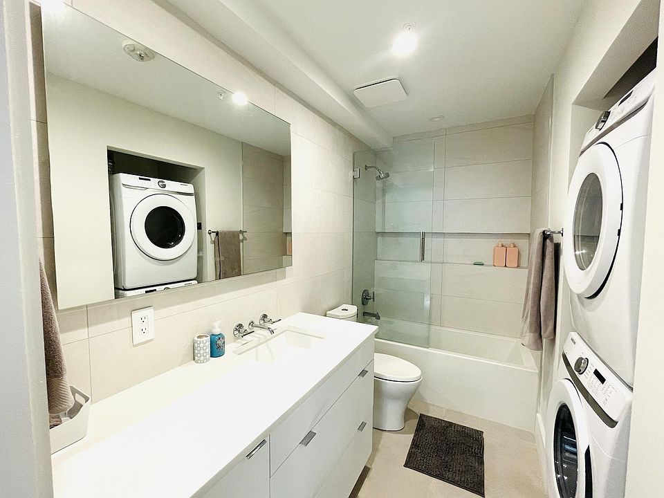 Smart mirror, ample counter space, soaking bathtub and rain shower head. Full size high efficiency washer and dryer.