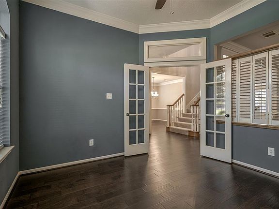 Private home office with French doors overlooking the front of the home.