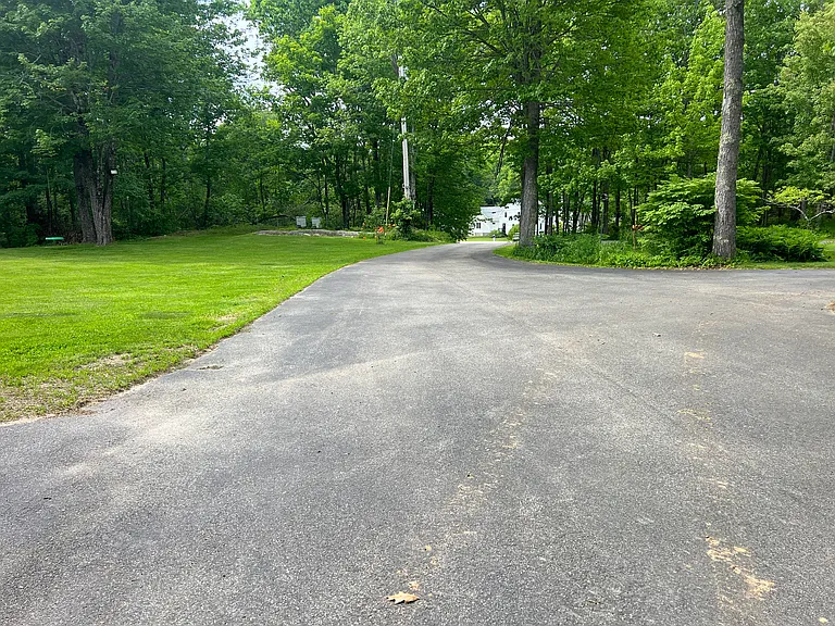 Home and apartment sit back off the road