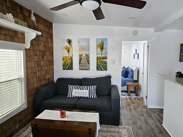 Bright and airy living room with recessed lighting and fan