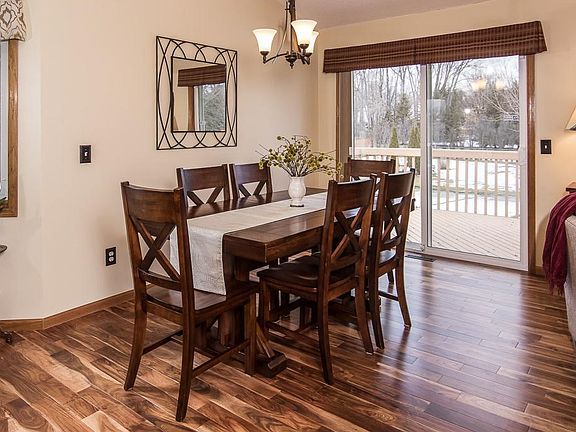 The dining room is spacious and features updated lighting. Expand your living space with access to the deck and backyard.