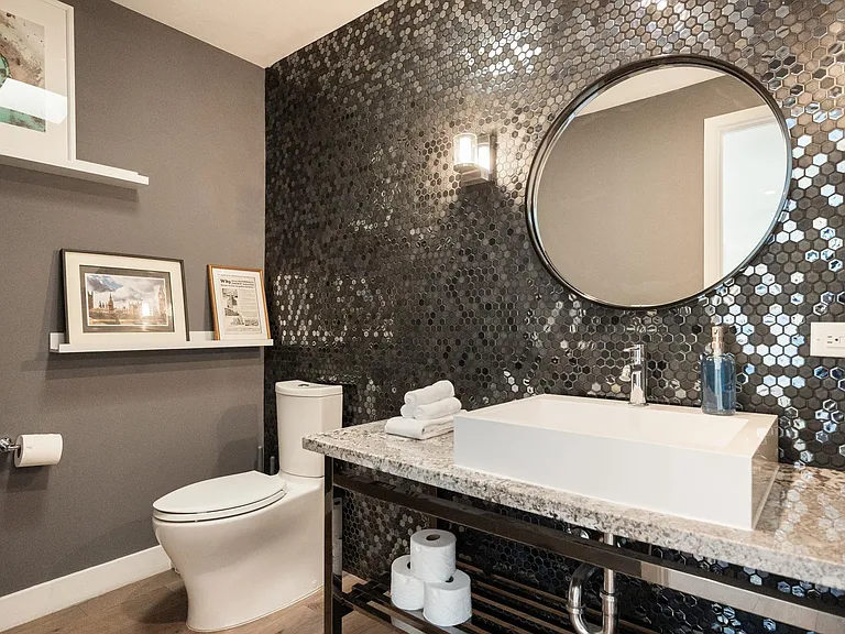 Refresh in the elegant half bathroom, featuring modern amenities and sophisticated decor.