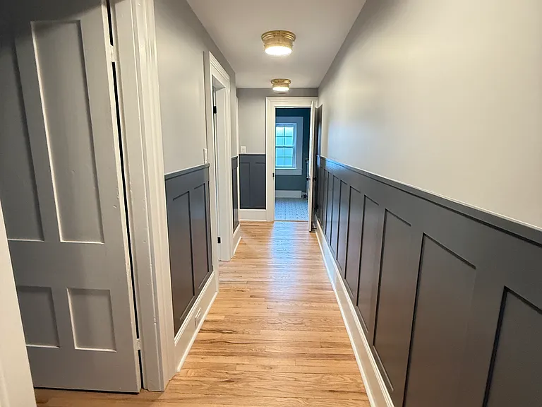 Upstairs hallway leading to bedrooms and primary bathroom.