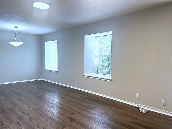 Another view of living and dining area. Nice big windows with natural light.
