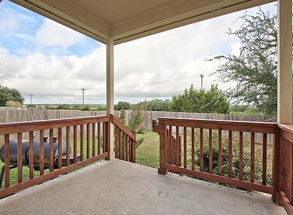 Panoramic views of fields and wooded areas are enjoyed from the covered patio.
