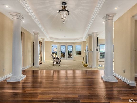 You will say "WOW" when you enter the foyer. Three sets of Tuscan columns with up lighting and directional lighting lead you through the living room to the outdoor living space. Beautiful Brazilian cherry hardwood floors enhance the entry and flow through the den, dining room and kitchen....