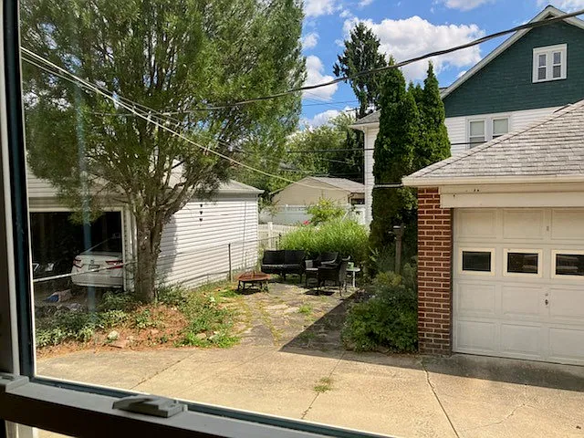1/2 of garage behind house with parking plus a sandstone patio