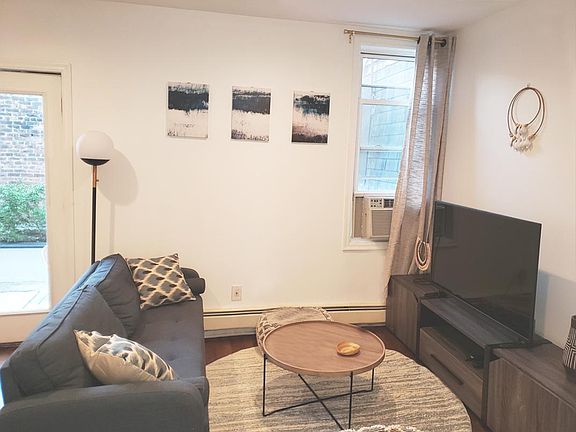 Living room. Enjoy the 50" new TV with smart features for your entertainment so you can watch channels like Netflix, which is also included in the rent.