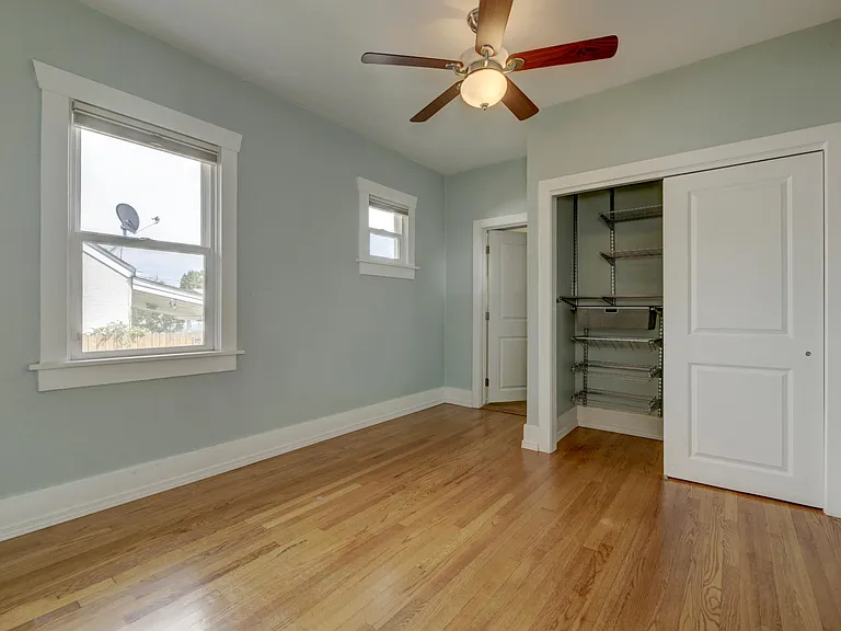 Master bedroom with Elfa Shelving for optimal storage. Attached full bath ahead.