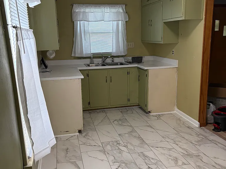 Kitchen with new tile. Refrigerator, stove and dishwasher to be installed next week and pictures will be retaken