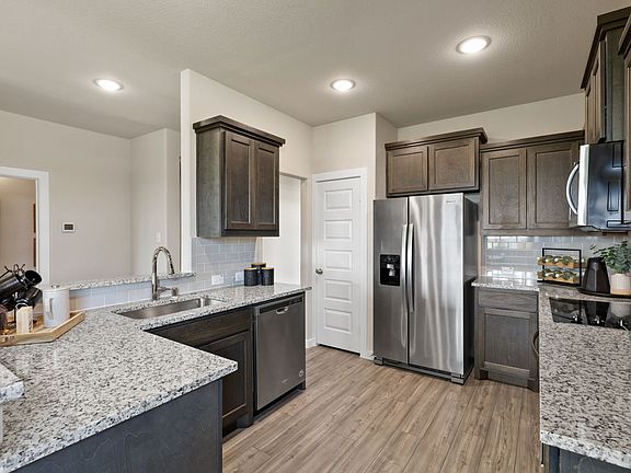 Kitchen in the Topaz home plan by Trophy Signature Homes - REPRESENTATIVE PHOTO