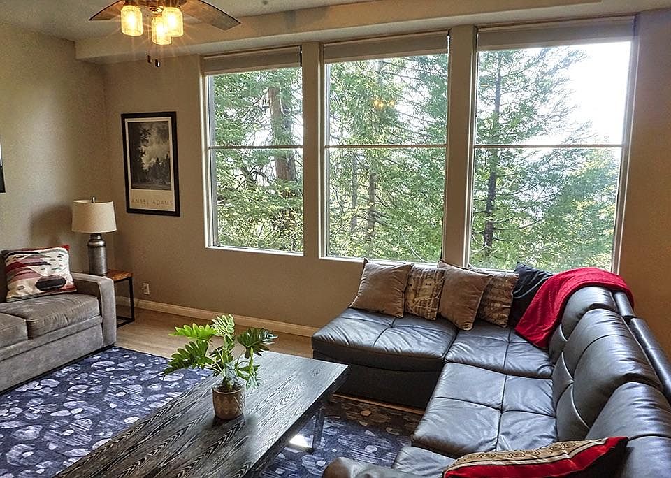 Living room with treetop and lake views