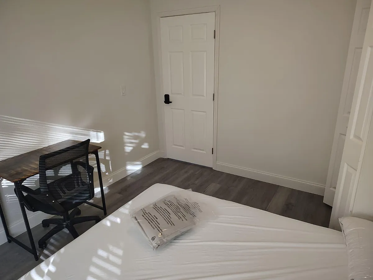 Private bedroom with durable flooring, a dedicated desk/work area, and closet storage for everyday convenience. - Walton Way