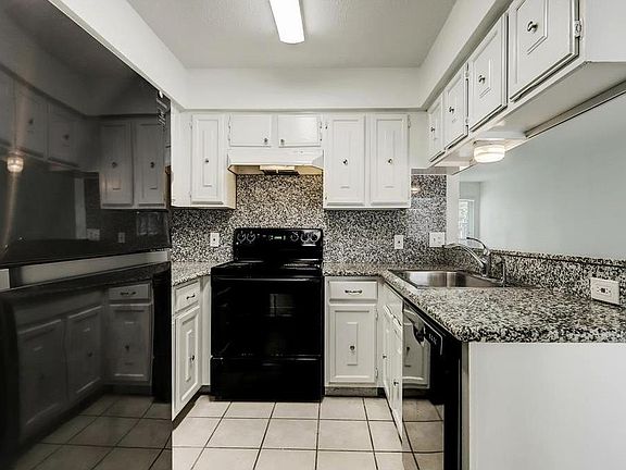 Kitchen with brand new fridge and electric stove top