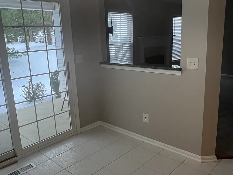 Dining area with viewing area into living room.