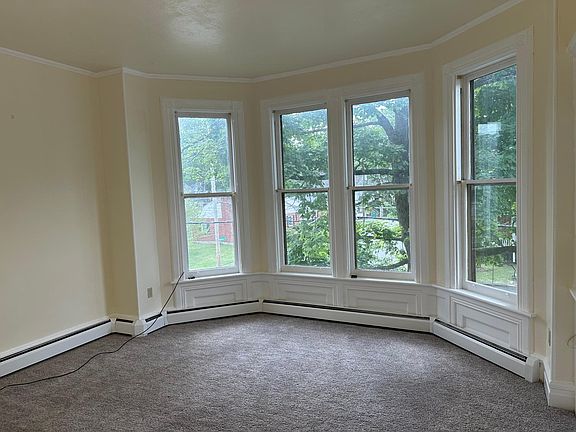 There are large bay windows in the living room looking out onto Analomink St. The ceiling is 10 feet tall, giving the room a feeling of space.