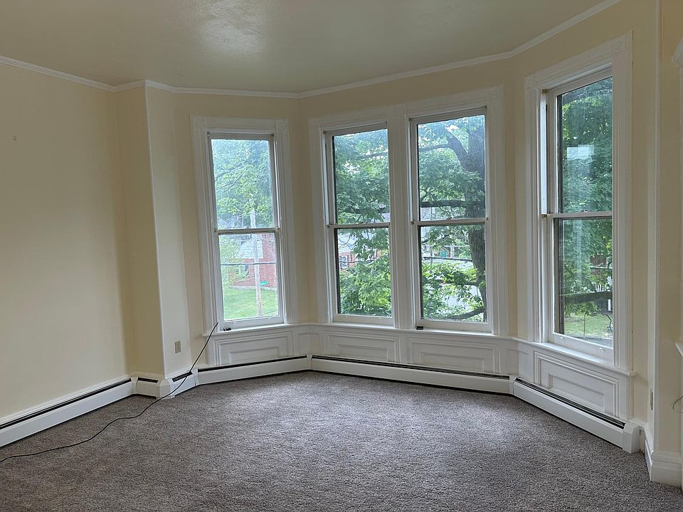 There are large bay windows in the living room looking out onto Analomink St. The ceiling is 10 feet tall, giving the room a feeling of space.