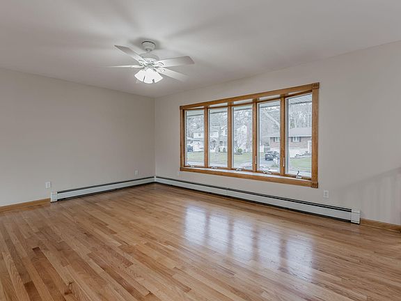 Living room with large bow window. Lots of natural light.