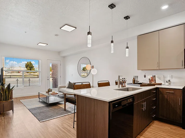 From cooking to relaxing, the kitchen and living area seamlessly blend together to create a welcoming space for gathering, entertaining, and enjoying daily life.