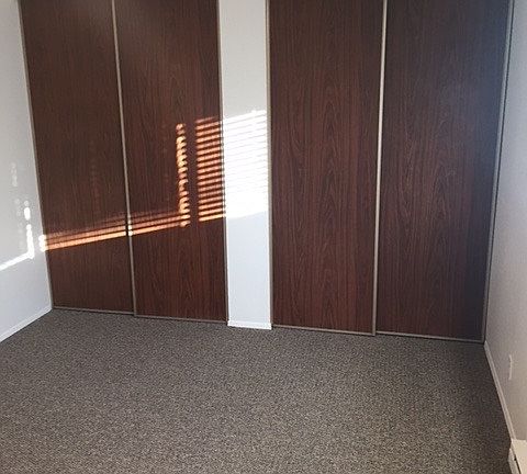 Bedroom with 3 pairs of closets
