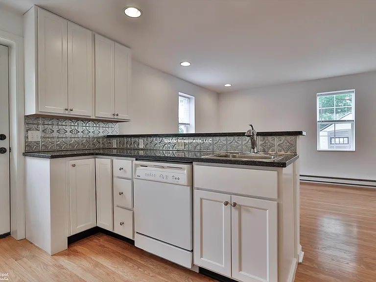 View of the sink, dishwasher, and great room