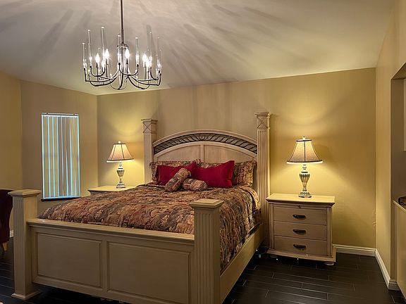 Primary bedroom features a California King Bed with ensuite bath. Lots of storage, oversized closet and mounted 55" smart TV.