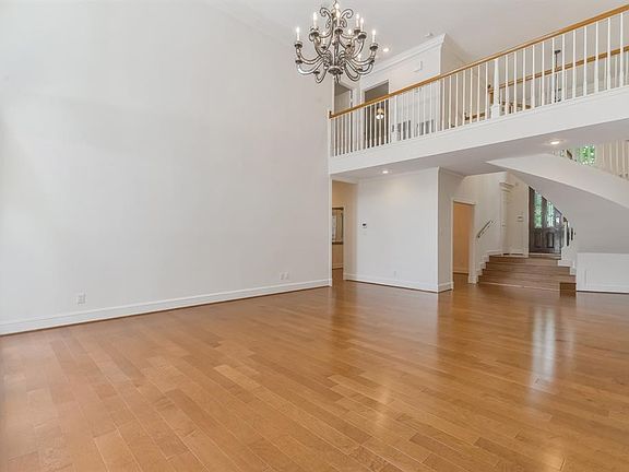 View of the entry hall, staircase and second floor walkway from the living room.