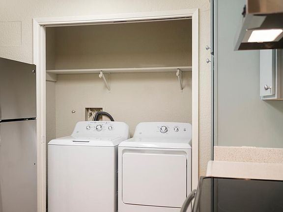 Apartment homes at Sunset Gardens include a full sized washer and dryer, ceiling fan, walk-in closet, living room with wood burning tiled fireplace and bay window. Exact features, flooring, colors, and dimensions vary from one apartment to another and may