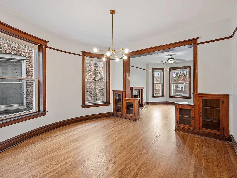 Freshly refinished hardwood flooring throughout the dining room and living room